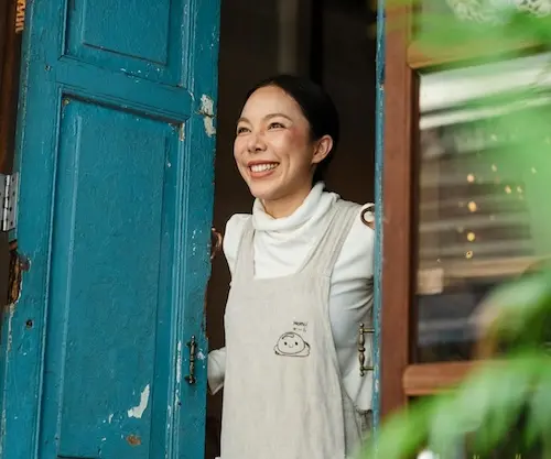 Woman holding open door